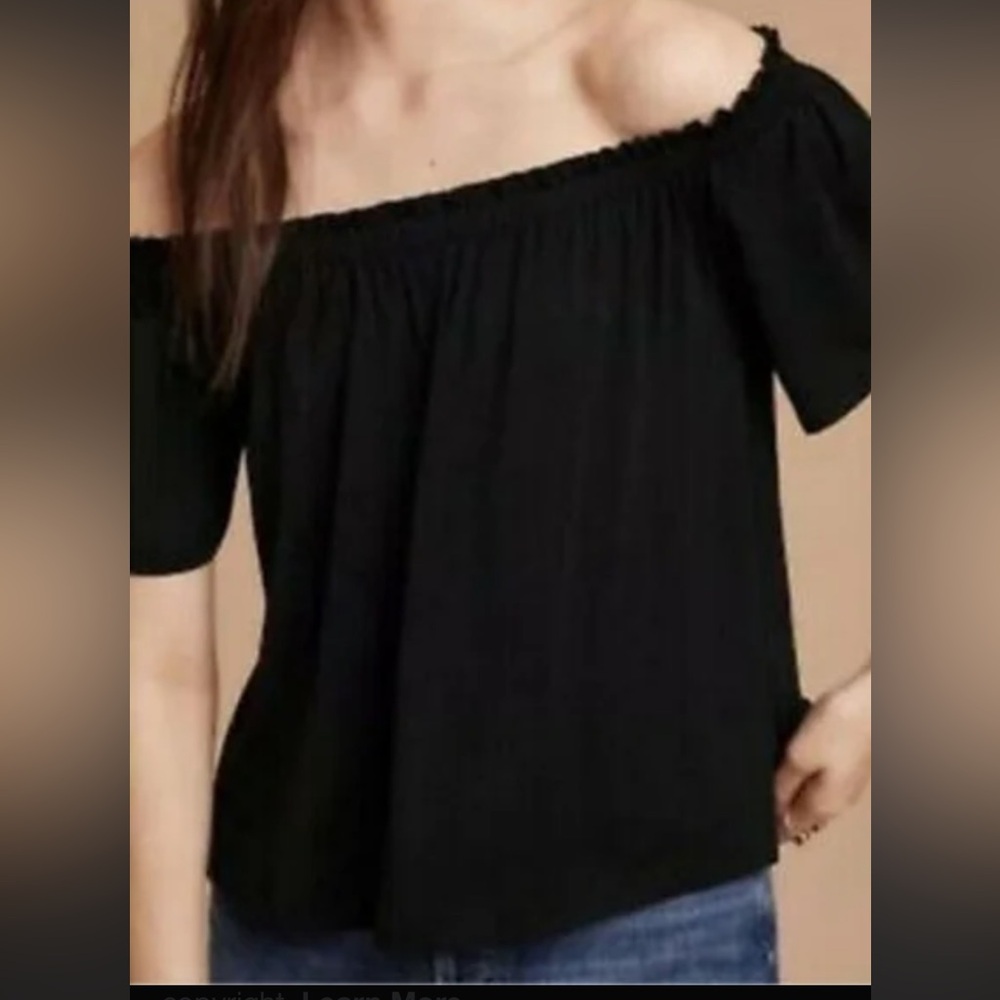 Babaton Black Off-Shoulder Blouse with side slits at the hip.